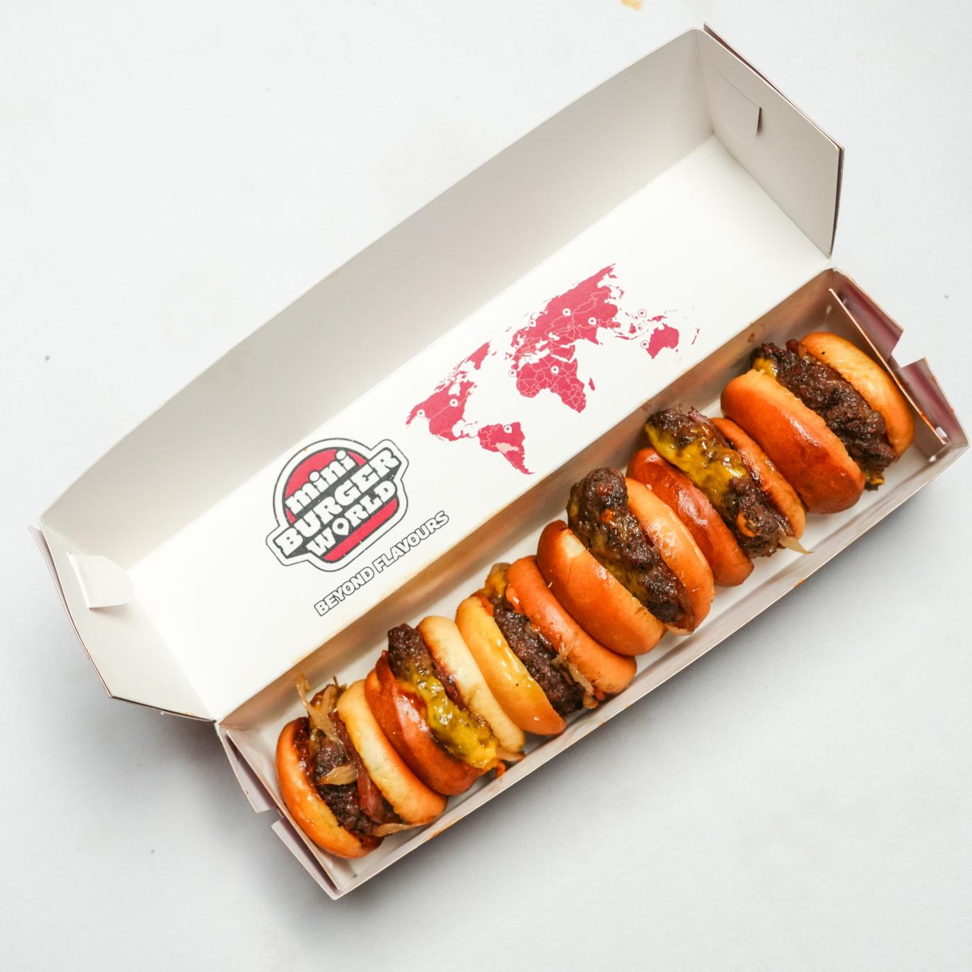 Mini burgers lined up in a Mini Burger World box